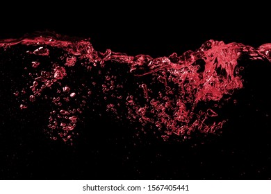 Clear splash wave surface of red wine or juice water with drops. Isolated on a black