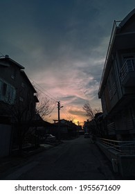 Clear sunset with clouds between buildings