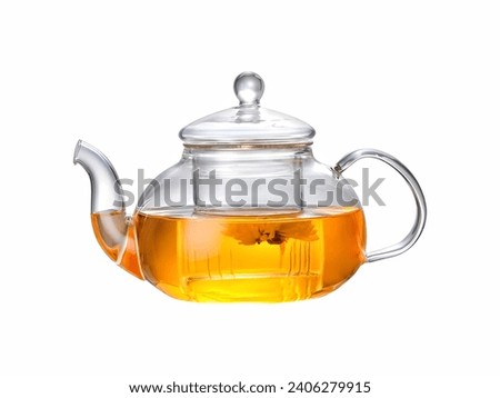 A clear teapot reveals amber tea, with a floating tea leaf, showcasing the purity and richness of the brew.