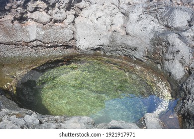 A Clear Tide Pool Hole Among The Volcanic Coast Of Maui, Hawaii