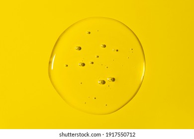 Clear Transparent Round Liquid Gel Drop Or Smear Isolated On Yellow Background. Top View. Virus Protection Or Cosmetics Concept. Serum Texture