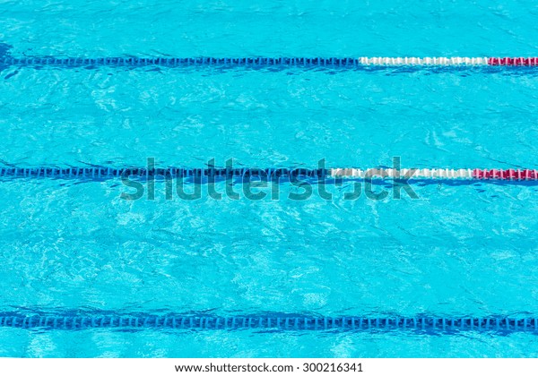 Clear transparent swimming pool water background.\
Selective focus