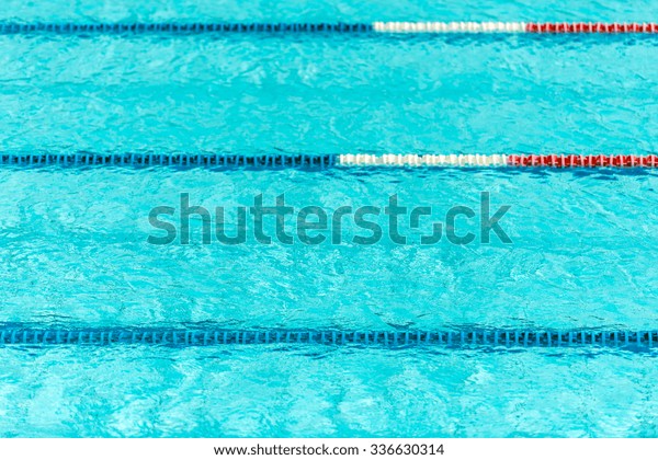 Clear transparent swimming pool water background.\
Horizontal shot