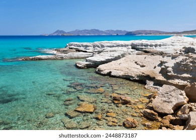 Clear turquoise sea and volcanic rock formations at Sarakiniko, Sarakiniko, Milos, Cyclades, Aegean Sea, Greek Islands, Greece, Europe - Powered by Shutterstock