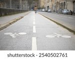 A clear view of a two-way bike lane in a city, illustrating safe cycling infrastructure and encouraging sustainable urban mobility.