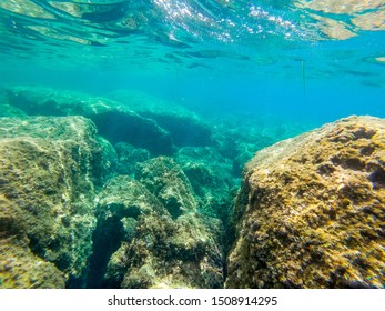 Clear water and rocks in Sardinia, Italy. Underwater point of view