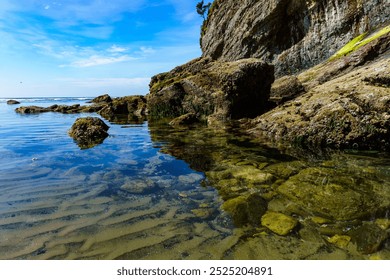 Clear water Tide pool with Rock Formation on Short Sand Beach at Cape Falcon Oregon - Powered by Shutterstock