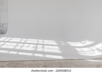 Clear White Cyclorama. Light Background With Sun Light And Shadows. Plain Wall Empty Photo Studio. . High Quality Photo