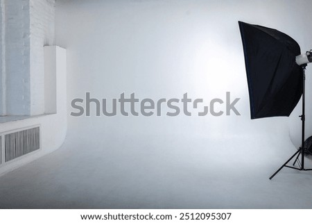 Clear white cyclorama. Light background with with professional lighting equipment. Plain wall empty photo studio