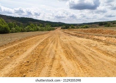 Clearing, grading, leveling and clearing of vegetation on land field for the construction of road or highway - Shutterstock ID 2129205398