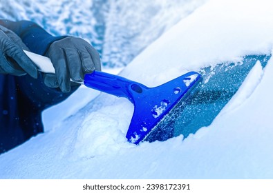 Clearing and remove snow from windshield, Scraping ice. Winter season car window cleaning. Copy space for your text. Panoramatic banner.