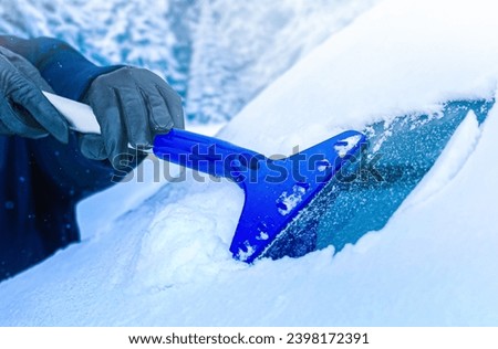 Clearing and remove snow from windshield, Scraping ice. Winter season car window cleaning. Copy space for your text. Panoramatic banner.