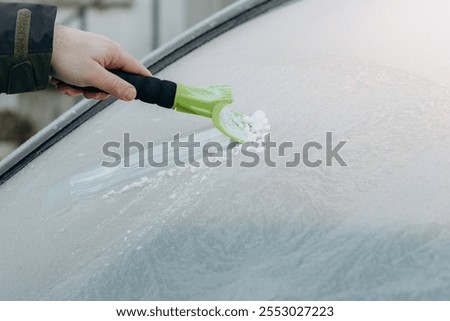 Clearing and remove snow from windshield, Scraping ice. Winter season car window cleaning. Copy space for your text. high quality photos. free space