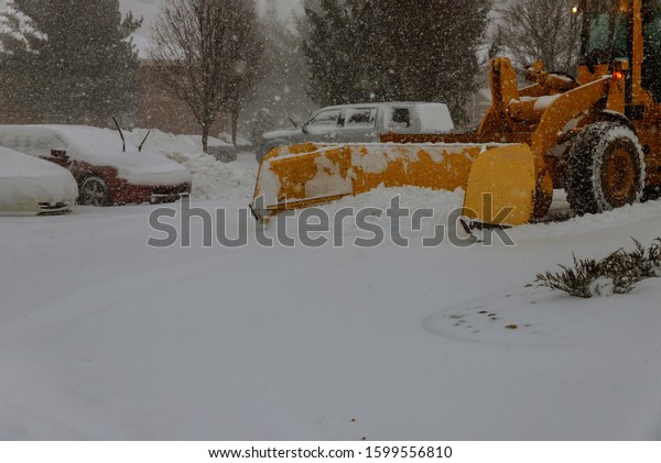 Clearing snow on the road in the parking for\
cars winter snow\
background