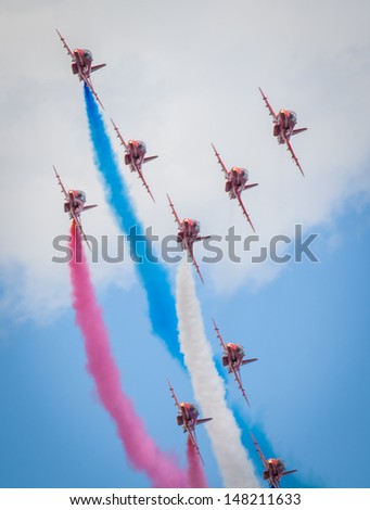 CLEETHORPES, ENGLAND JULY 28TH: Royal Air Force Red arrows perform an aerobatic display at Cleethropes airshow on 28th July 2013 in Cleethorpes England.