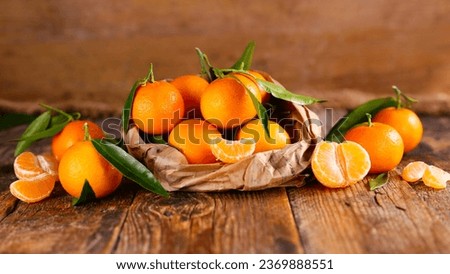 clementine and leaf on wood background