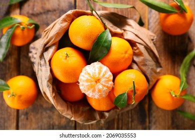 clementine- mandarin fruit and leaf background