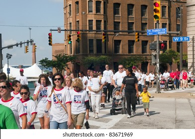 CLEVELAND - AUGUST 27 : Participants In The 2011 Cleveland Heart Walk, Sponsored By The American Heart Association, Cross A Busy Intersection On August 27 2011 In Cleveland.