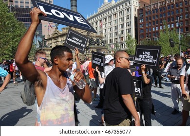 Cleveland, OH July 20, 2016: Republican National Convention - Protester holding a "Love" Sign walks through the crowds