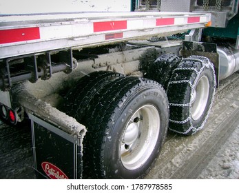 Cleveland, OH / USA - February 11, 2013: Snow Tires Are Being Installed On The Wheels Of A Tractor Trailer Truck Getting Ready For A Long Haul In Rough Weather