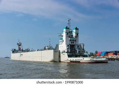 Cleveland, Ohio June 13, 2021: The articulated combination of tugboat Samuel de Champlain and barge Innovation reverse into the Cuyahoga River to deliver a load of cement to the local LaFarge plant