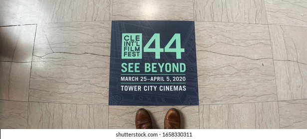 Cleveland, Ohio / USA - February 26 2020: Two Boots Symbolize Person Observing Advertisement In Floor Tile For “44 See Beyond” At Tower City Cinemas For The Cleveland International Film Festival.