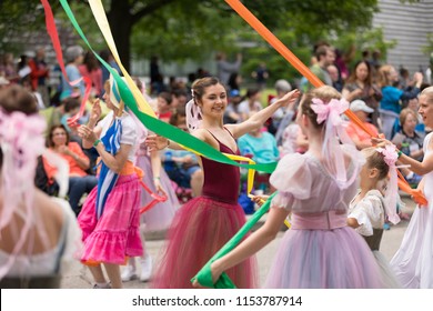 Cleveland, Ohio, USA - June 9, 2018 women wearing traditional german clothing perform the maypole dance At the abstract art festival Parade The Circle