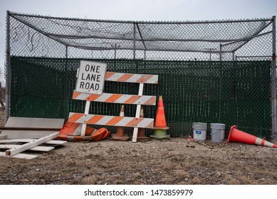 Cleveland, Ohio - USA/ March 09 2019: Miscellaneous road safety equipment resting along fence.