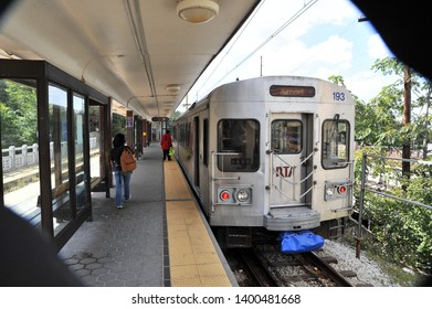 CLEVELAND, OHIO / USA - SEPTEMBER 18 2009: Passengers board RTA train bound for Airport at elevated platform Red line station.