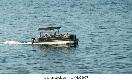 Cleveland, Ohio/USA - July 4, 2019: Pontoon Boat With Family Motoring Across Lake Erie Along Edgewater Park In Downtown Cleveland During Fourth Of July Festivities.