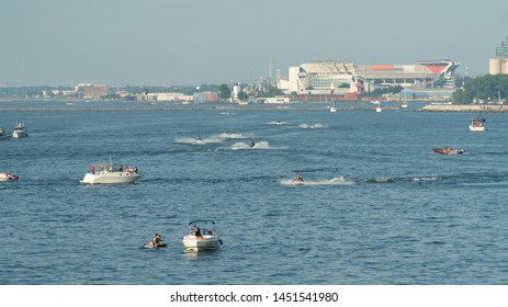 Cleveland, Ohio/USA - July 4, 2019: Water Craft Scene On Lake Erie With Small Fishing Boat Vessels And Jet Skis Cruising Near Downtown Cleveland's First Energy Stadium.