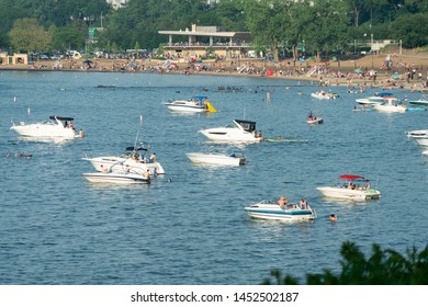 Cleveland, Ohio/USA - July 4, 2019: Crowds And Beach Goers Gather At Edgewater Park For The Weekend Festivities And July Fourth Excitement With Fishing Boats Lining Lake Erie.