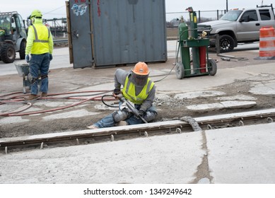 Cleveland, Ohio/USA -  March 15 2019: Large, Loud, And Diverse Construction Crew Work On The Corner Of W Huron Rd And Ontario St Across From The JACK Parking Garage And Tower City Station.