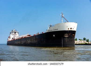 Cleveland, USA - July 5, 2019:  Owned by the American Steamship Company and built in 1979 the bulk carrier M/V American Courage shuttles iron ore to a local steel mill on the Cuyahoga River