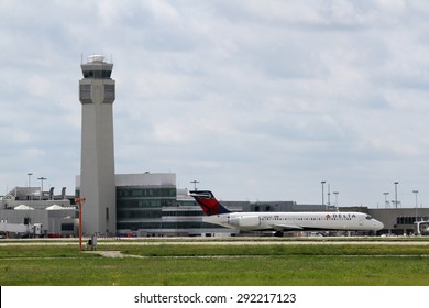 CLEVELAND, USA - JUNE 30, 2015: Delta Boeing 717-200 at Cleveland Hopkins International Airport just leaving the terminal, with the control tower in view. 