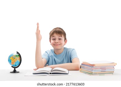 Clever Boy Raised His Hand High In Class. Portrait Of Schoolboy With Notebooks And Textbook. White Background. Excellent Student