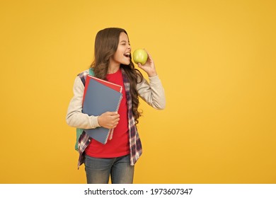 Clever Eating. Little Kid Eat Apple Yellow Background. School Break. Fruit Snack. Brain Food. Cognitive Health. Diet And Dieting. Every Girl Should Be Eating Healthy Food, Copy Space