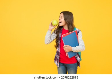 Clever Eating. Little Kid Eat Apple Yellow Background. School Break. Fruit Snack. Brain Food. Cognitive Health. Diet And Dieting. Every Girl Should Be Eating Healthy Food, Copy Space