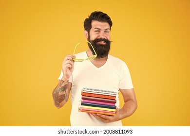 Clever forever. Happy student yellow background. University student hold books. Smart student smile with glasses. Student back to school. University. Higher education - Shutterstock ID 2008811093