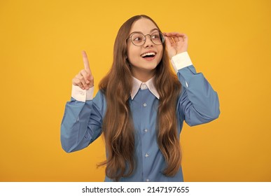 Clever idea. Clever girl in eyeglasses yellow background. School age child with raised finger. Eureka - Shutterstock ID 2147197655