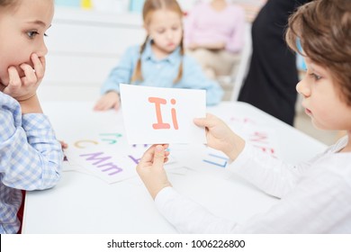 Clever Little Kids Learning English Alphabet At Lesson, Boy Showing Paper Card With Letter I