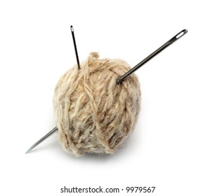 clew of wool thread and two needles close-up
