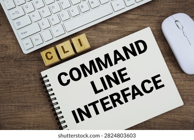 CLI Command-Line Interface message with keyboard and optical mouse on wooden background
