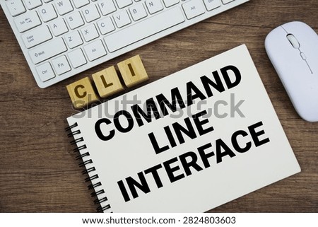 CLI Command-Line Interface message with keyboard and optical mouse on wooden background