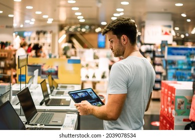 Client Choosing Laptop In Store