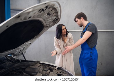 A Client Complains To A Workman About A Bad Car Repair