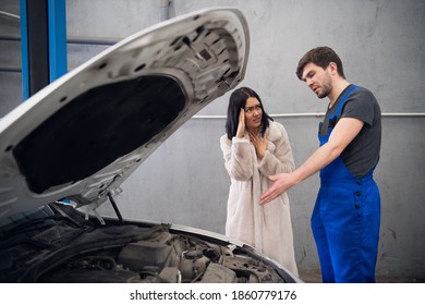 A Client Complains To A Workshop Worker About A Bad Car Repair