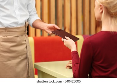 Client Getting Bill From Waiter At Restaurant, Closeup