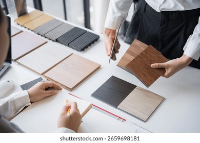 Client and interior designer selecting materials for home decoration in collaborative consultant