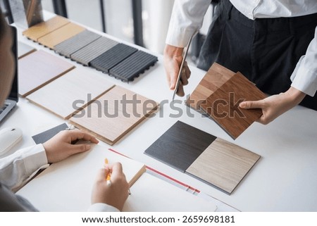 Client and interior designer selecting materials for home decoration in collaborative consultant